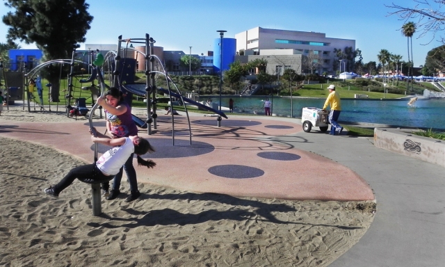 playground and lake with East Los Angeles Civic Center in background
