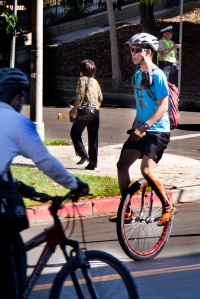 man riding unicycle