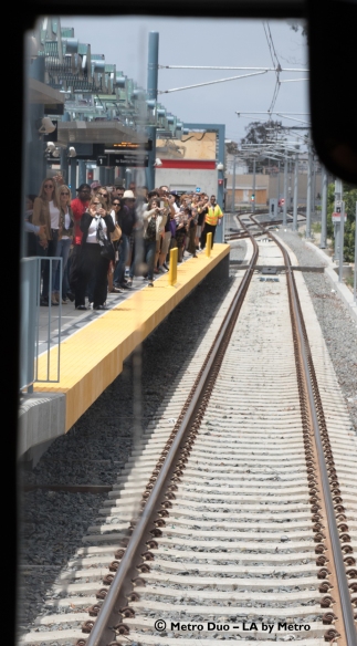 A crowd waited for the train on the platform of the Westwood/Rancho Park Station.
